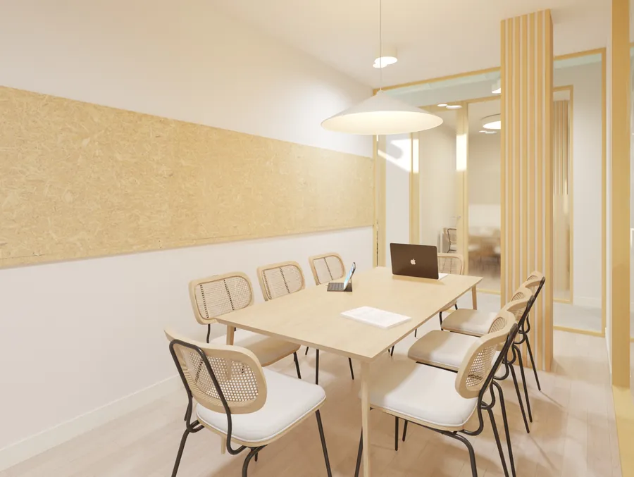 Despacho de reuniones con la mesa de madera y las sillas de rejilla